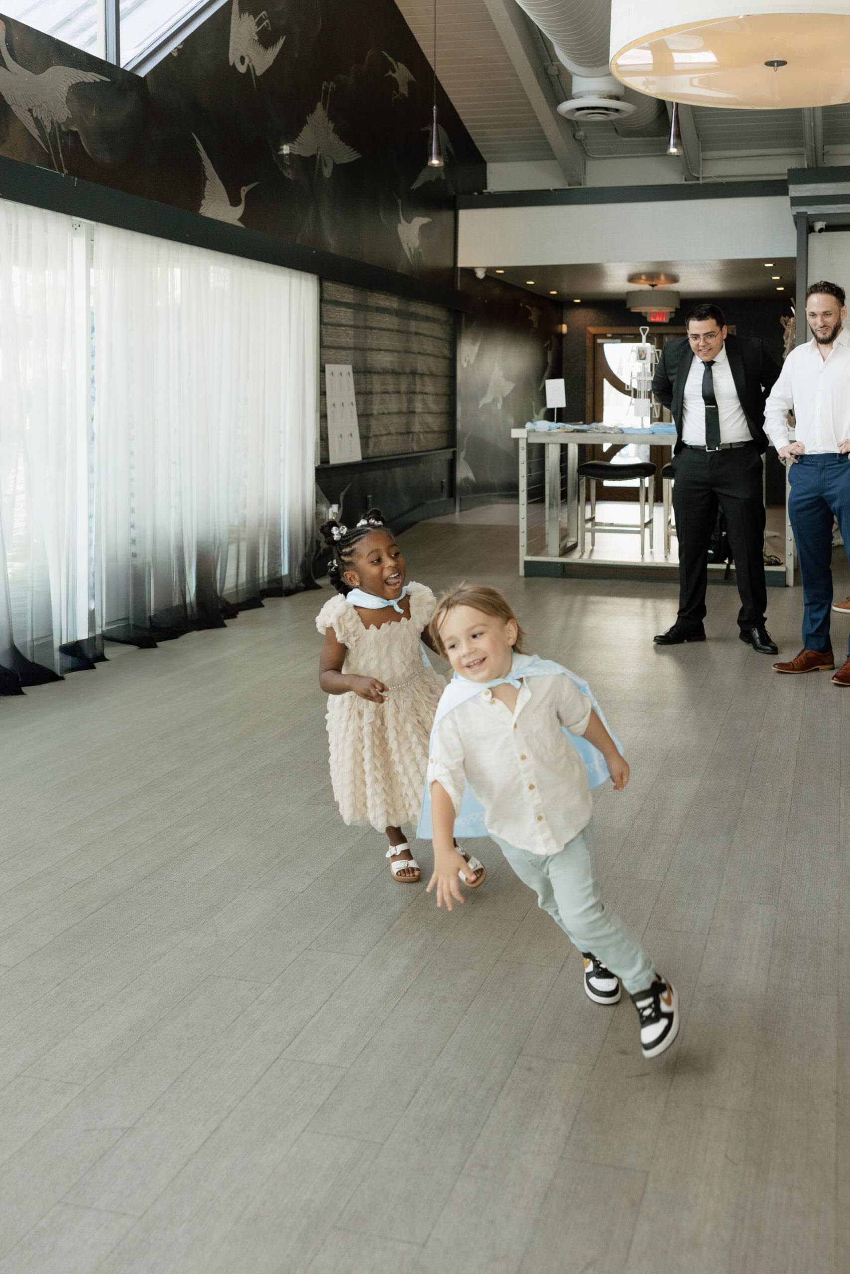 Children running and laughing at intimate wedding reception at Grateful Palate Fort Lauderdale