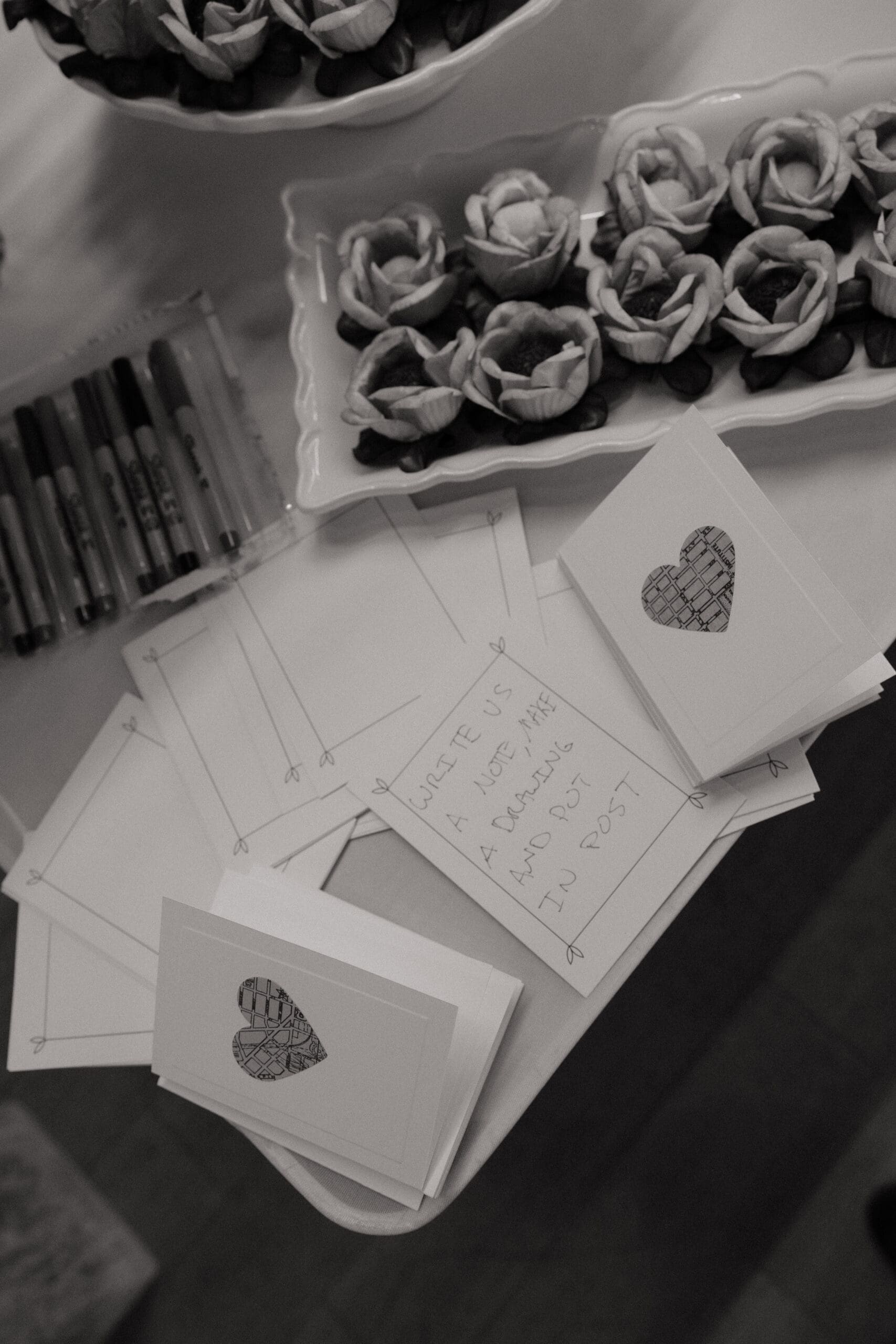 Black and white photo of travel-themed wedding guest note cards at intimate reception Fort Lauderdale